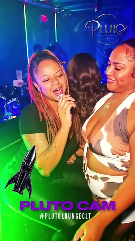Two friends singing under green light