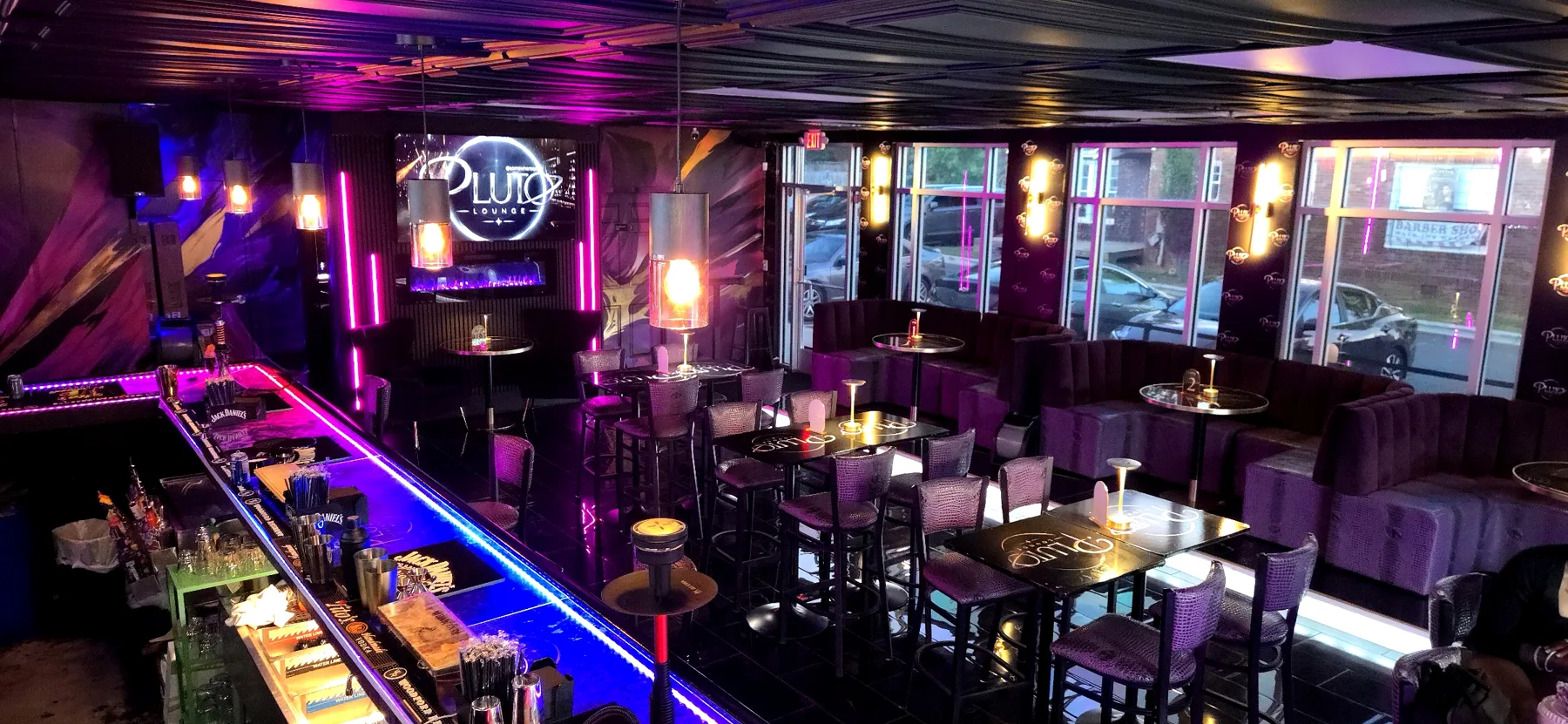 Inside Pluto Lounge: the neon bar, violet booths and the Pluto sign