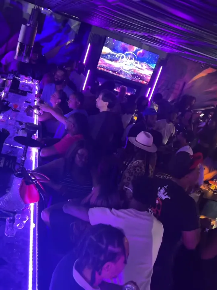 Full house under purple lights at Pluto Lounge